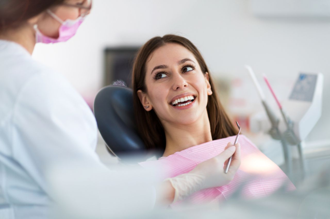 woman-similing-dentist-chair woman smiling at dentist